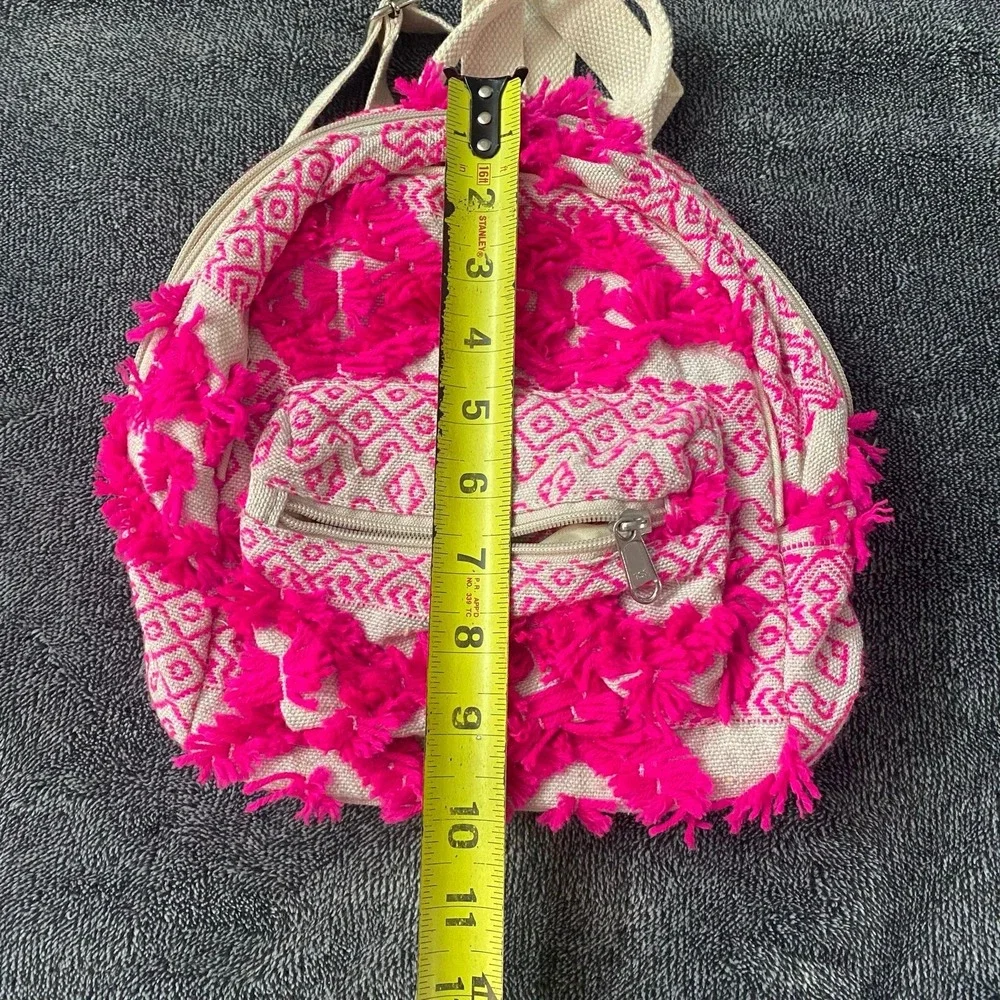 Boho fringe mini backpack in neon pink and coral canvas.